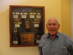 Dad in front of medal case.jpg