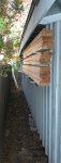 Shop tour 24 -Cedar stored on the back wall of the shop -small.JPG