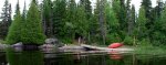 Totem pole and canoes from the water -small.JPG