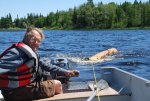 Totem carved at Pellow's Camp 05 -Frank towing cedar log for totem behind boat -2 -small.JPG